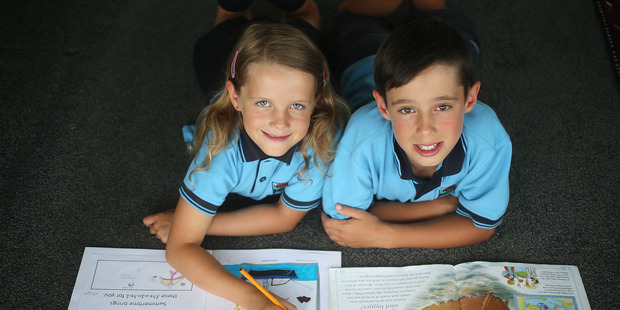 Reading is the focus of homework for Lucy and Dylan Henderson, who also love helping with chores. Photo / Doug Sherring